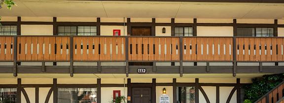 A sign for Oak Park Apartments is in front of a building.