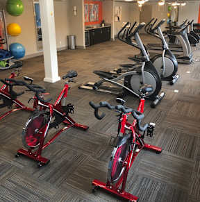a room full of bikes and weights in a gym