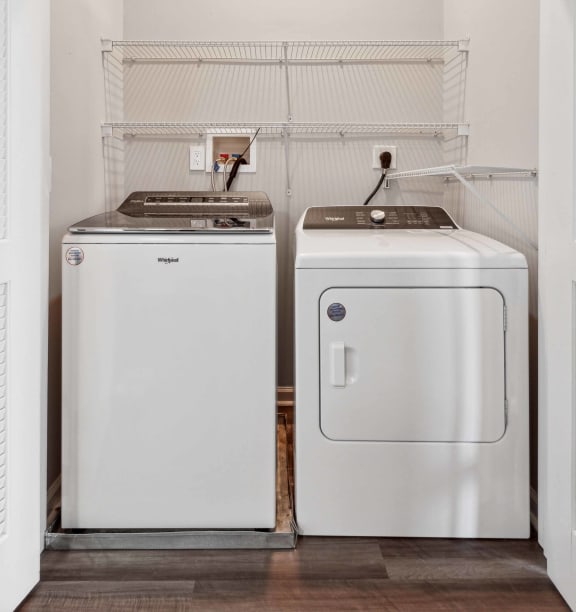 a small laundry room with two washes and a dryer at Metro 303, Hempstead, NY