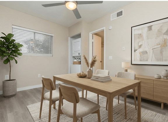 A dining room with a table set for four.