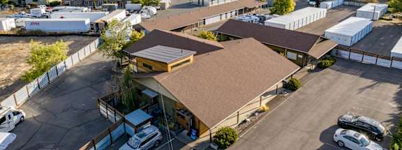 A parking lot with cars and a building in the background.