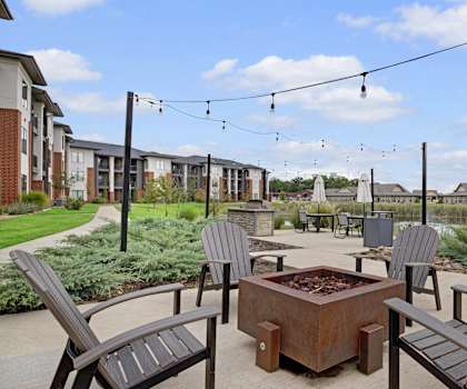 An outdoor patio with chairs and a fire pit at 49 West. 