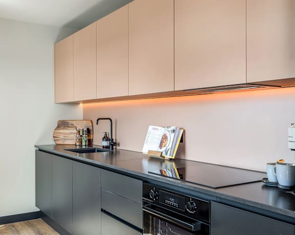 Kitchen detail showing worktop cabinetry and integrated oven.
