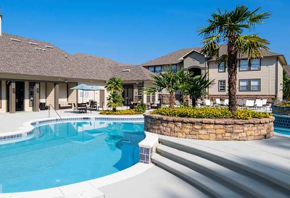 A large house with a pool in front.