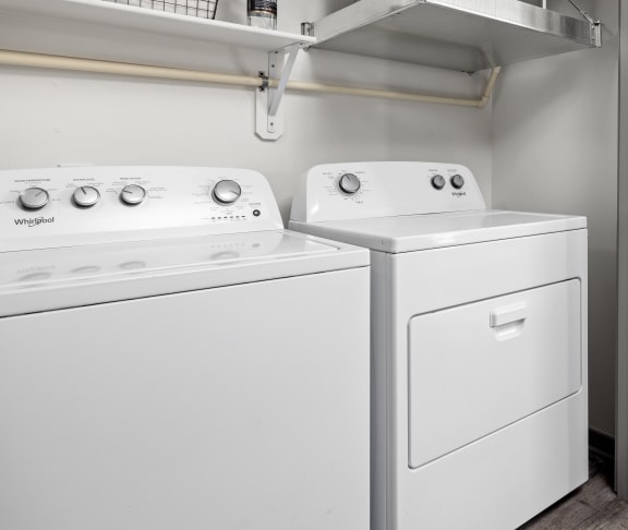a white washer and dryer in a room with a refrigerator and a door at Upland Flats, Colorado, 80922