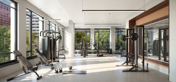 a gym with a lot of equipment and large windows