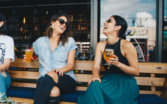 two women sitting on a bench drinking beer at SECOND AVE COMMONS | BRAND-NEW, Mesa, AZ, 85210