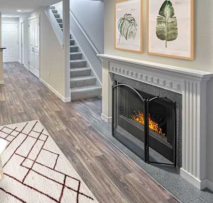 a living room with a fireplace and a table and chairs