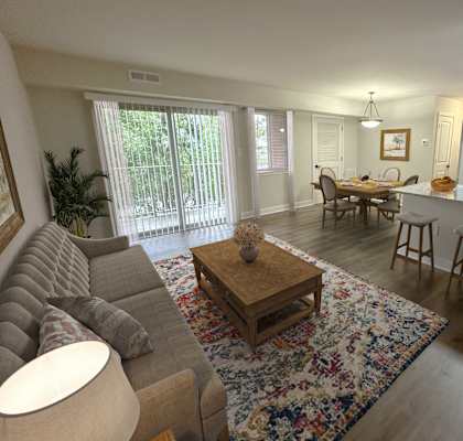 a view of a living room and a kitchen with a table and chairs