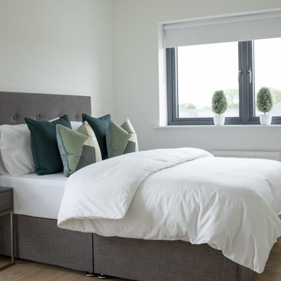 a bedroom with two beds and a window