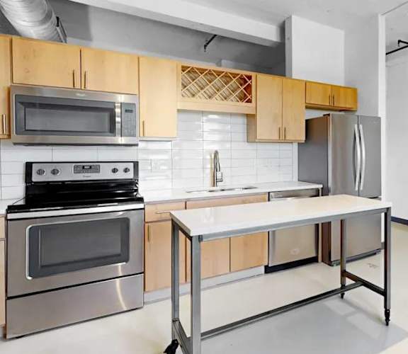 A kitchen with a stove top oven and microwave.
