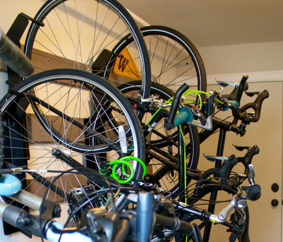 a rack of bikes in a room with a door