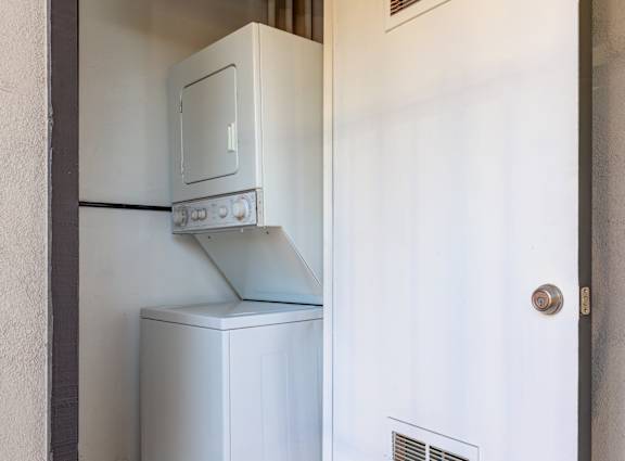 a white refrigerator and freezer in a room with a door