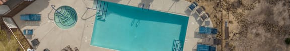 An aerial view of a swimming pool surrounded by a fence.