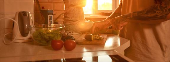 Two people are lying down and looking at something together.