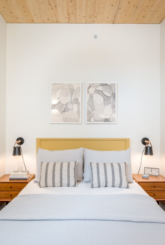 Studio Apartments in Eugene OR - Crosswood Apartments - Bedroom with White Walls, Plush Bed, and Two Night Stands
