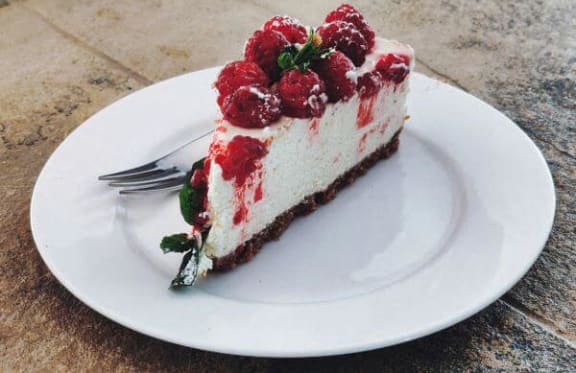 a piece of cake on a white plate with a fork