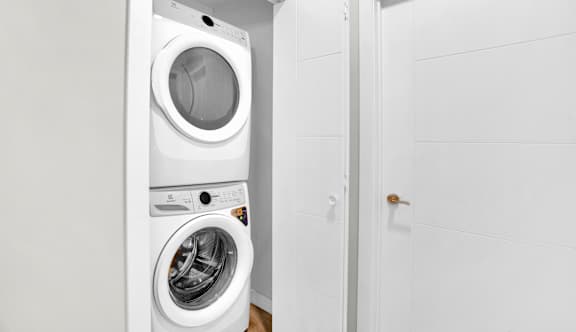 A white washing machine and dryer in a small laundry room.