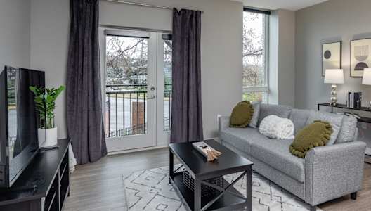 an open living room with a couch and a television