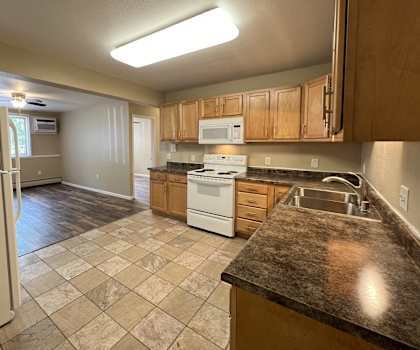 a kitchen with an island and a stove and a refrigerator