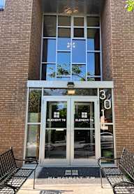 The front of a building with a glass door and windows.