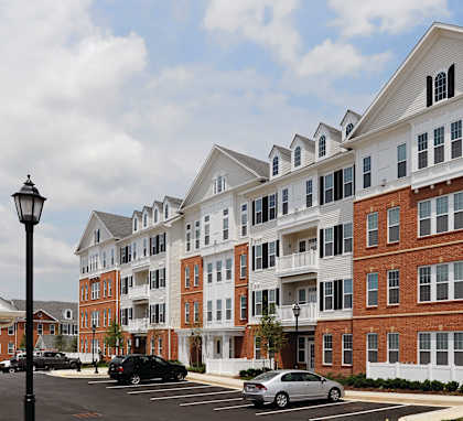 A large red brick building with a white trim around the windows and roof.