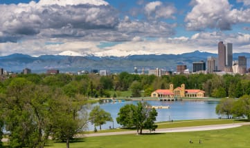 a city with a lake and mountains in the background