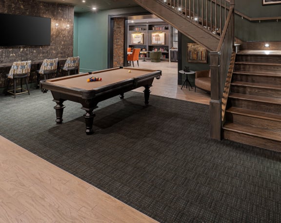 a games room with a pool table and a staircase at The Madison in OH 43215