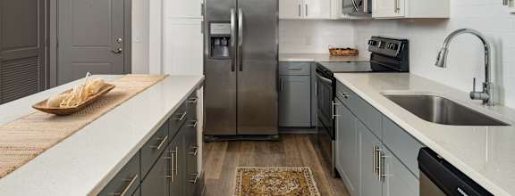 A kitchen with a wooden island in the middle.