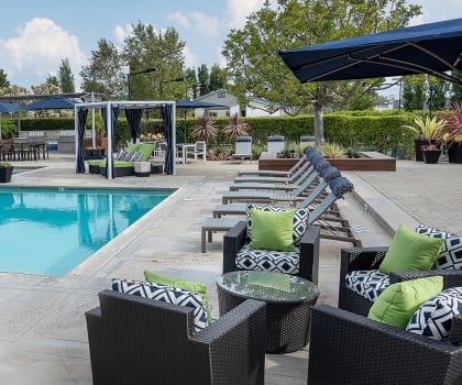 a swimming pool with lounge chairs and umbrellas at the resort at governors crossing