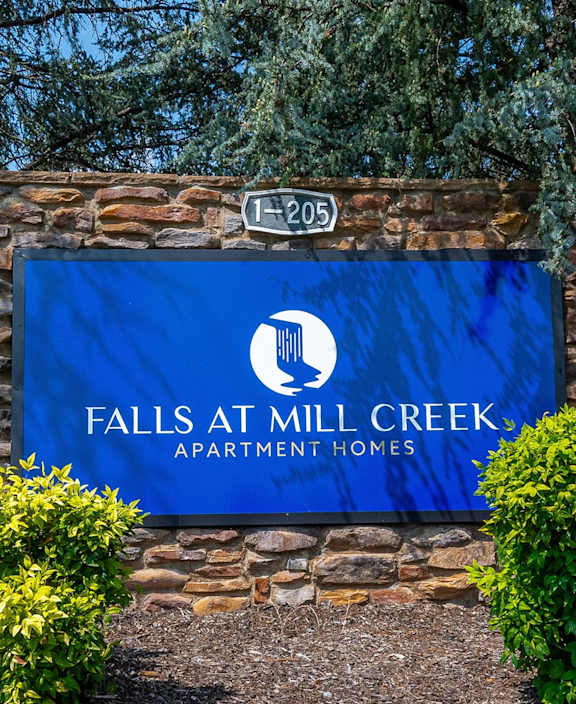 falls apartment homes sign at the entrance of the property