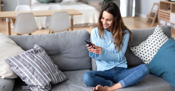 Woman on couch with phone