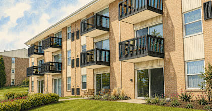 A large apartment building with balconies and doors.