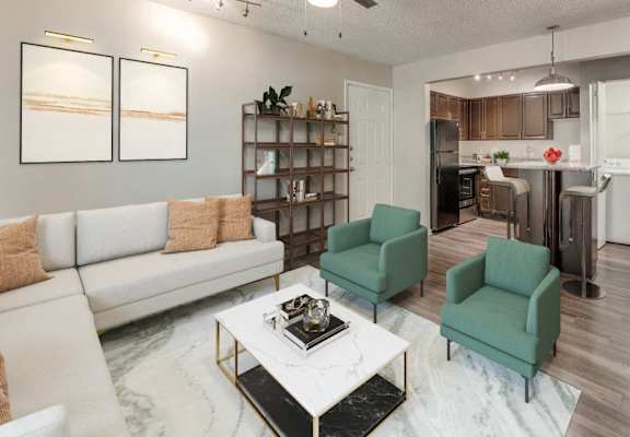 an open living room and kitchen with a white couch and a table  at Vibe on Riverside, Austin, Texas