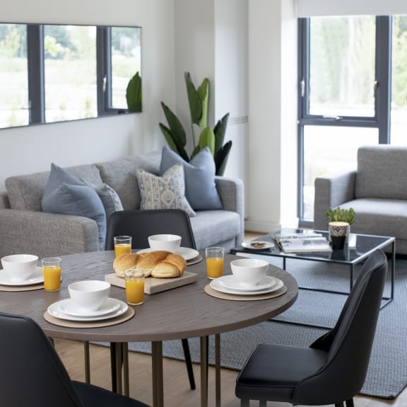 a living room with a table and chairs and a couch