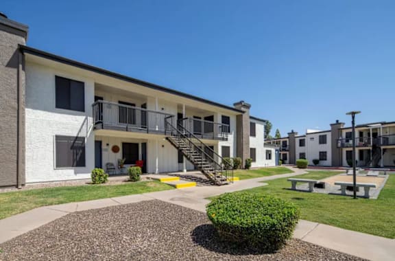 A sunny day at a residential complex with a clear blue sky.