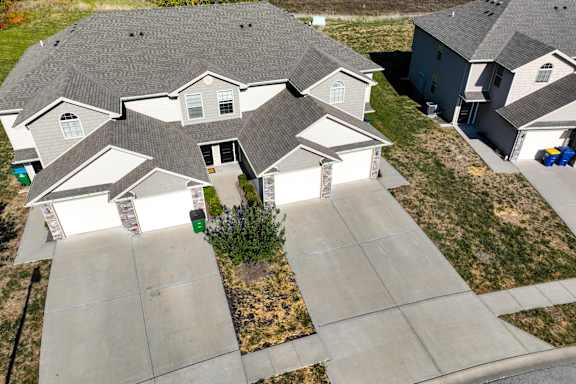 A suburban neighborhood with houses and a pond.