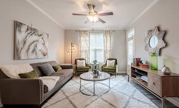 a living room with a ceiling fan and a couch