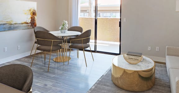a living room and dining room with a table and chairs at The Peak at Oro Valley Apartments, Arizona, 85704
