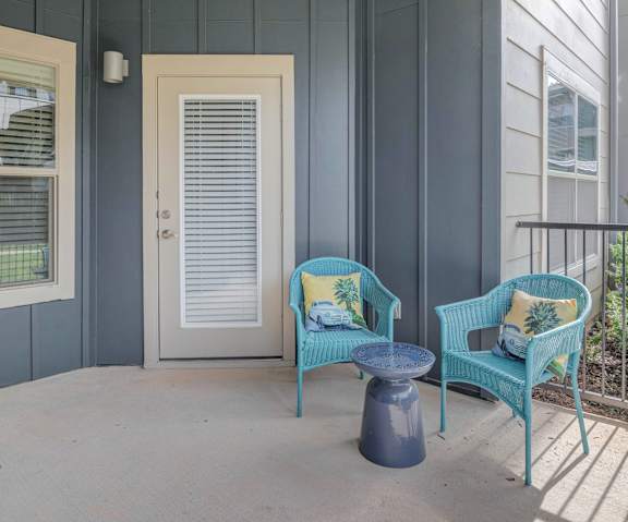 Balcony with a Blue Chair at Legacy Flats Apartments, Texas
