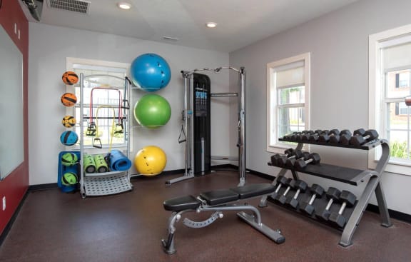 a home gym with exercise equipment and windows