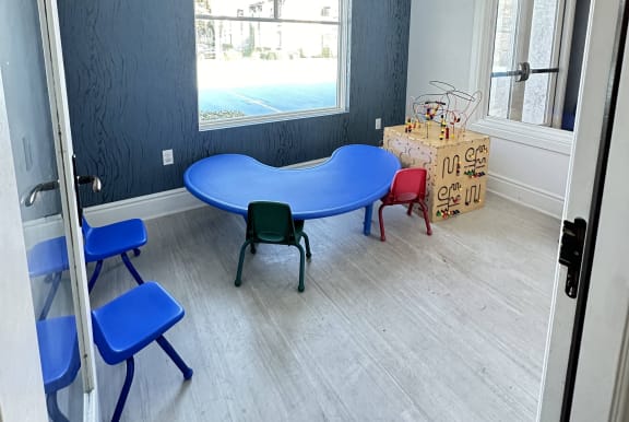 a childs play room with a blue table and chairs at The Bryant Apartments at Yorba Linda, California, 92887