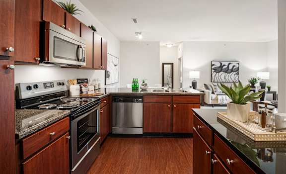 A kitchen with dark wood cabinets and a black countertop. at Aventura at Richmond, Missouri, 63376