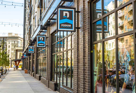 A building with the company logo at Podium Apartments, Calgary, AB