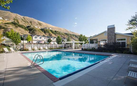 Swimming pool with lounge chairs and mountain views at Liberty Hill Apartments, Draper, 84020