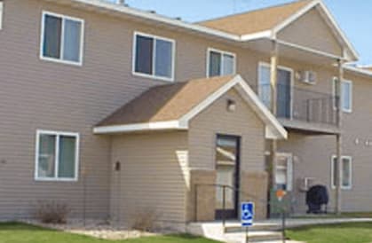 Apartment building with a blue handicap sign in front.