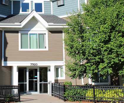 an apartment building with a street in front of it