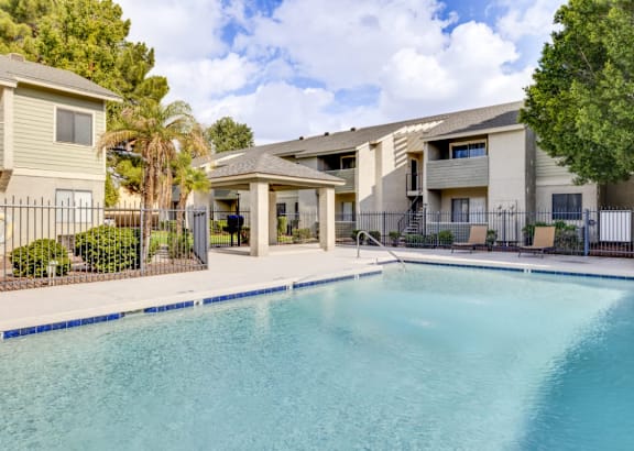 A swimming pool in front of apartment buildings.