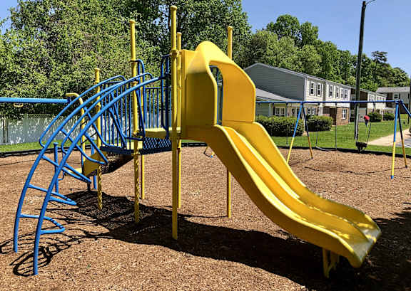 a playground with a slide at a park at Colony Townhomes, Raleigh, 27609