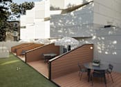 Thumbnail 2 of 13 - a terrace with a table and chairs in front of a white building